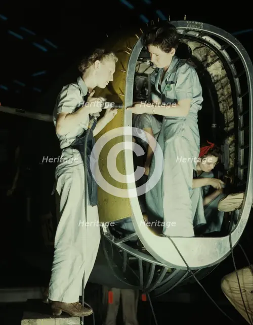 Riveters at work on fuselage of Liberator..., Consolidated Aircraft Corp., Fort Worth, Texas, 1942. Creator: Howard Hollem.