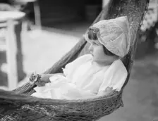 Rice, Isaac, Mrs., grandaughter of, in a hammock, 1920 July 26. Creator: Arnold Genthe