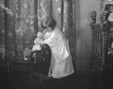 Rice, Isaac, Mrs., grandaughter of, playing with a doll, 1920 May 27. Creator: Arnold Genthe