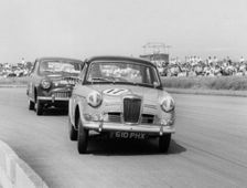 Riley 1.5, Grace leads Jack Sears in Austin Westminster at Silverstone 1958. Creator: Unknown