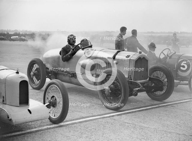 Riley, Buick and Bugatti on the start line at a Surbiton Motor Club race meeting, Brooklands, 1928. Artist: Bill Brunell.