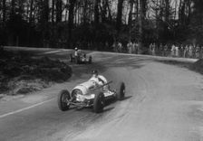 Riley of Hector Dobbs leading the MG Q type of Kenneth Evans, Donington Park, Leicestershire, 1935. Artist: Bill Brunell