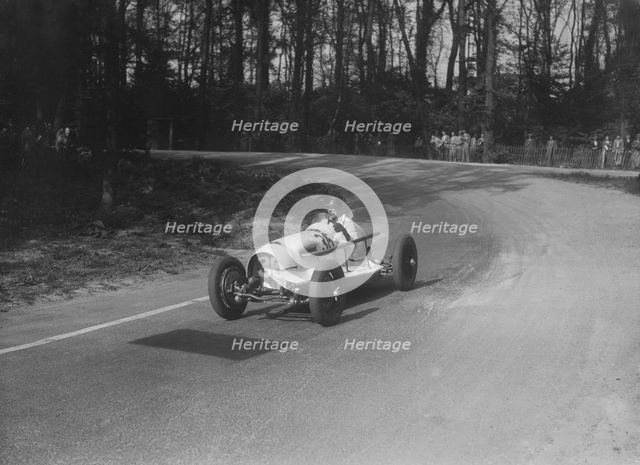 Riley offset-bodied single seater of Hector Dobbs racing at Donington Park, Leicestershire, 1935. Artist: Bill Brunell.
