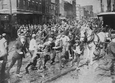Rioters charging horse-drawn car, later wrecking it on Kensington Ave., Philadelphia, 1910. Creator: Bain News Service