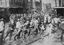 Rioters charging horse-drawn car, later wrecking it on Kensington Ave., Philadelphia, 1910. Creator: Bain News Service