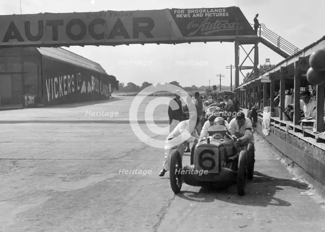 'Rubber Duck', works Austin 7 of Charles Goodacre in the pits, BRDC 500 Mile Race, Brooklands, 1931. Artist: Bill Brunell.