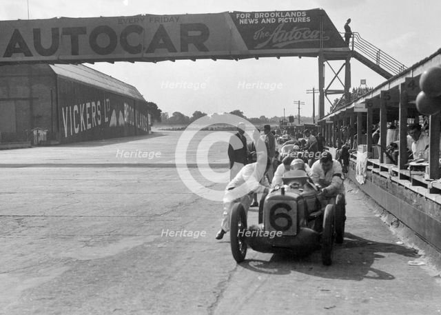 'Rubber Duck', works Austin 7 of Charles Goodacre in the pits, BRDC 500 Mile Race, Brooklands, 1931. Artist: Bill Brunell.