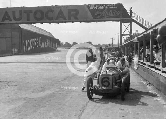 'Rubber Duck', works Austin 7 of Charles Goodacre in the pits, BRDC 500 Mile Race, Brooklands, 1931. Artist: Bill Brunell.