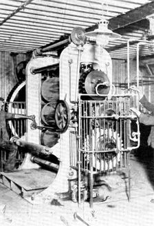 Rubber heels in the making: an elaborate calendering machine which flattens the raw rubber..., 1909. Creator: Unknown