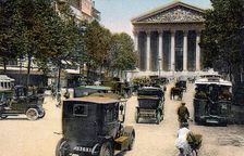 Rue Royale and the Madeleine, Paris, with cars and a motorbus on the street, c1900