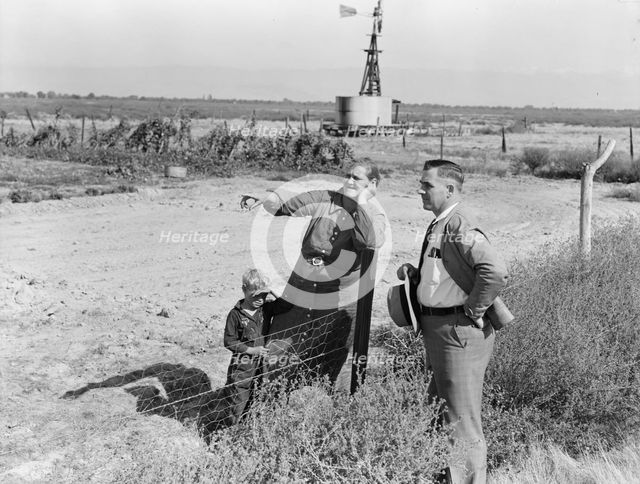 Rural rehabilitation client talking with county supervisor, FSA, Tulare County, California, 1938. Creator: Dorothea Lange.