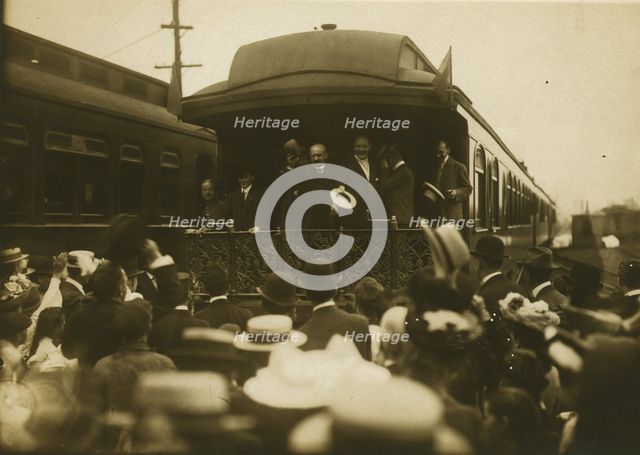 Russian diplomats waving at crowds from the back of a train car, 1905. Creator: Unknown.