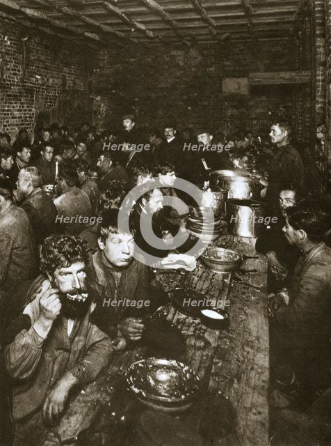 Russian manual labourers eating a meal, late 19th century.  Creator: Unknown.