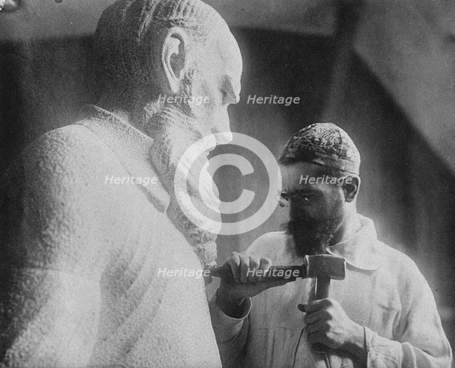 Russian sculptor Sergey Merkurov (1881-1952) working on his statue of Leo Tolstoy Artist: Anonymous  