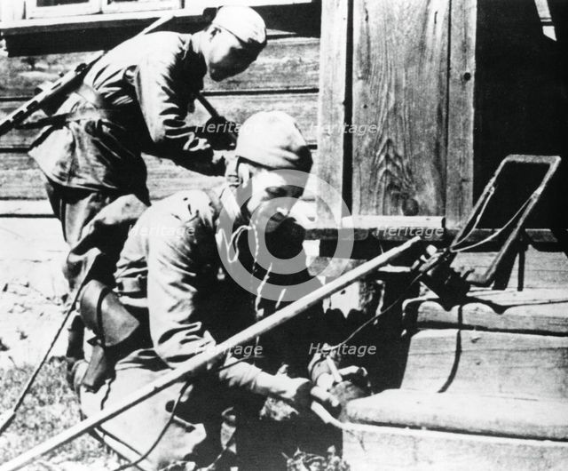 Russian soldiers with mine detectors clearing a booby-trapped house, Eastern Front, 1944. Artist: Unknown