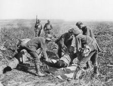Wounded German soldier being moved by prisoners, Aisne, France, 18 July, 1918