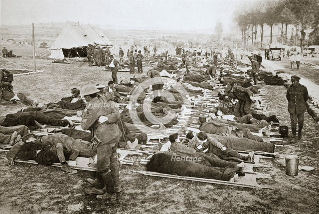 Wounded men waiting to be taken away to a clearing station, France, World War I, 1916. Creator: Unknown.