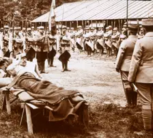 Wounded officer salutes the flag, c1914-c1918