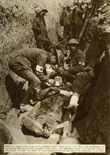 Wounded soldier being treated in the trenches, Battle of the Somme, First World War, 1916, (1935). Creator: Unknown