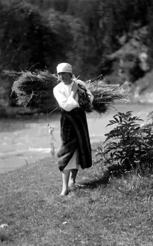Woman carrying a bundle of sticks, Bistrita Valley, Moldavia, north-east Romania, c1920-c1945. Artist: Adolph Chevalier