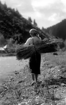 Woman carrying a bundle of sticks, Bistrita Valley, Moldavia, north-east Romania, c1920-c1945. Artist: Adolph Chevalier