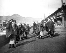 Woman carrying loads of coal, Nagasaki, Japan, c1900