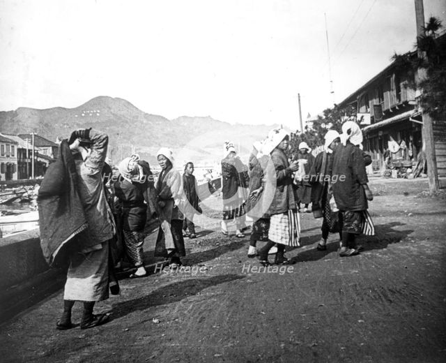 Woman carrying loads of coal, Nagasaki, Japan, c1900. Artist: Unknown