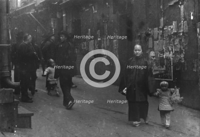 Woman and a child walking down a street, Chinatown, San Francisco, between 1896 and 1906. Creator: Arnold Genthe.