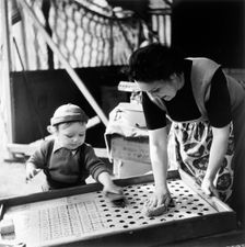 Woman and child at Hampstead fun fair, London, (early 1950s?). Creator: Henry Grant