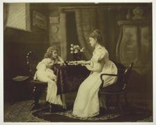 Woman and Child Playing Dominoes at Table, c. 1898. Creator: Unknown