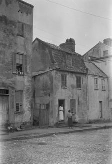 Woman and child standing in or by a doorway, [17 Chalmers Street], Charleston, South Ca., c1920-1926 Creator: Arnold Genthe