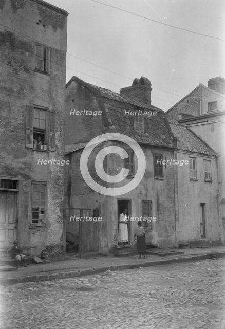 Woman and child standing in or by a doorway, [17 Chalmers Street], Charleston, South Ca., c1920-1926 Creator: Arnold Genthe.