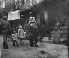 Woman and children walking down a street, Chinatown, San Francisco, between 1896 and 1906. Creator: Arnold Genthe