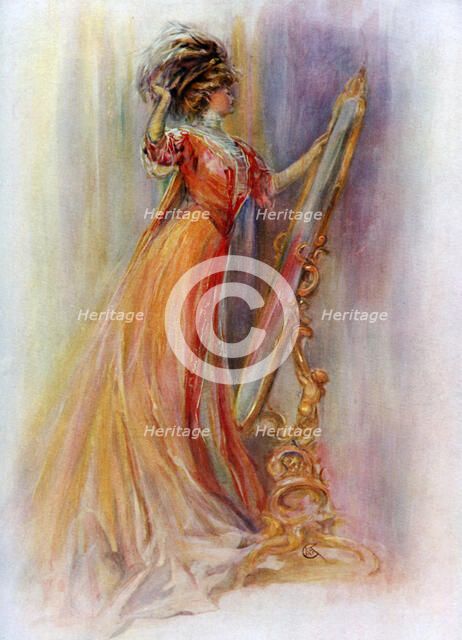 Woman admiring herself in a mirror, 1908-1909.Artist: Hubner & Wilson 