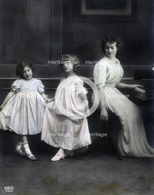 Woman at a piano with her daughters, Sweden, late 19th-early 20th century. Artist: Unknown