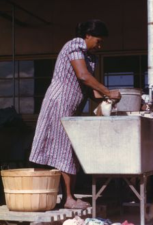 Woman at the community laundry on Saturday afternoon, FSA ... camp, Robstown, Tex., 1942. Creator: Arthur Rothstein