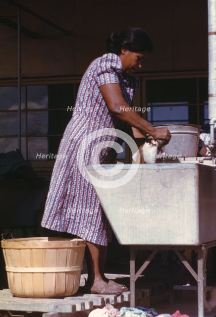 Woman at the community laundry on Saturday afternoon, FSA ... camp, Robstown, Tex., 1942. Creator: Arthur Rothstein.