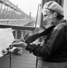 Woman busker playing the violin, Hungerford Bridge, London, 1946-1959. Artist: John Gay
