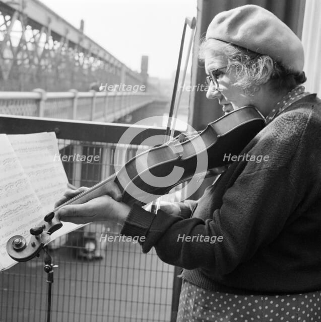 Woman busker playing the violin, Hungerford Bridge, London, 1946-1959. Artist: John Gay