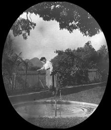 Woman by a pond in a garden, Rio de Janeiro, Brazil, late 19th or early 20th century