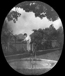 Woman by a pond in a garden, Rio de Janeiro, Brazil, late 19th or early 20th century