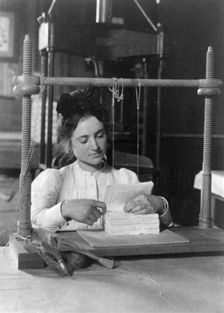 Woman doing bookbinding at Roycroft Shops, E. Aurora, N.Y., 1900. Creator: Frances Benjamin Johnston