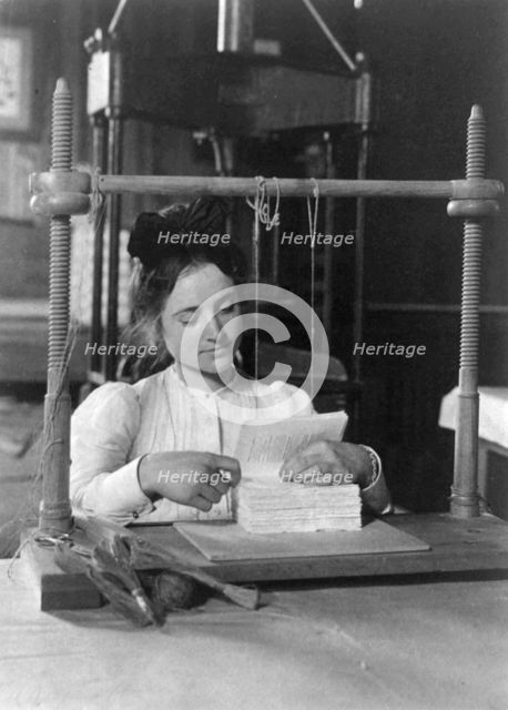 Woman doing bookbinding at Roycroft Shops, E. Aurora, N.Y., 1900. Creator: Frances Benjamin Johnston.