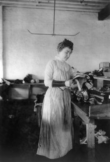 Woman distributing work in a shoe factory, Lynn, Mass., (1895?). Creator: Frances Benjamin Johnston