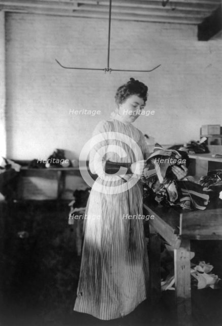Woman distributing work in a shoe factory, Lynn, Mass., (1895?). Creator: Frances Benjamin Johnston.