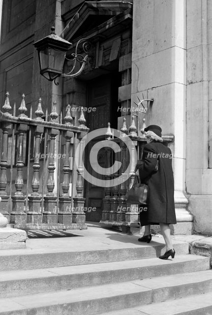 Woman entering the church of St Martin in the Fields, London, c1950. Artist: SW Rawlings