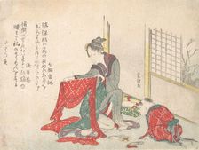 Woman Folding Cloth, late 18th-early 19th century. Creator: Hokusai