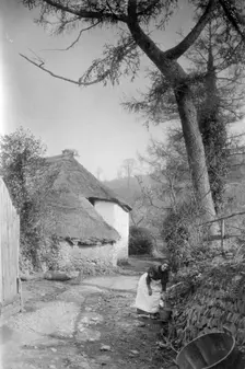 Woman fetching water, Bratton, Minehead, Somerset, c1900. Artist: Farnham Maxwell Lyte