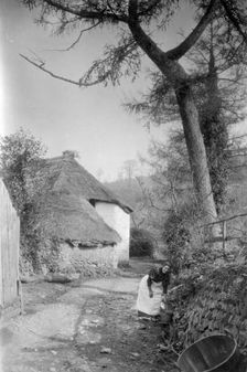Woman fetching water, Bratton, Minehead, Somerset, c1900. Artist: Farnham Maxwell Lyte