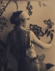 Woman, half-length portrait, facing right, viewed from behind, between 1920 and 1930. Creator: Adolph de Meyer